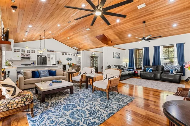 a living room with stainless steel appliances kitchen island granite countertop furniture and a kitchen view
