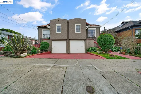 a front view of a house with yard and plants