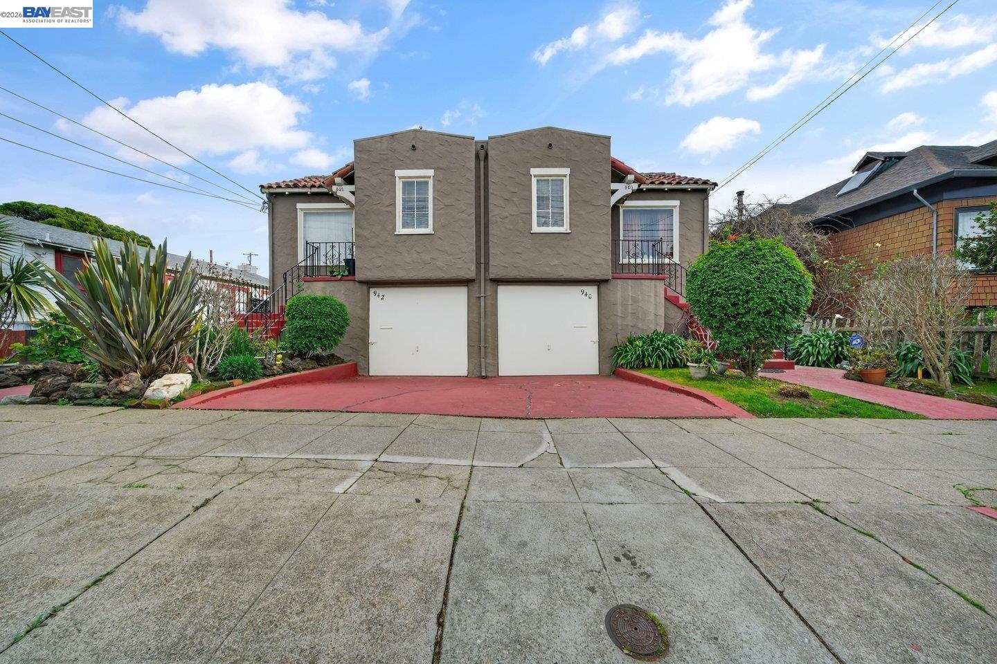 a front view of a house with yard and plants