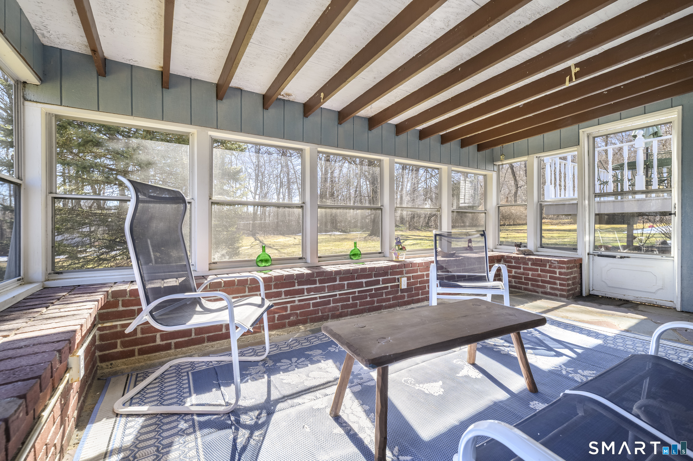 177 Putting Green Road Fairfield, CT 06825 - Photo 18 of 22 Three season patio steps down from deck