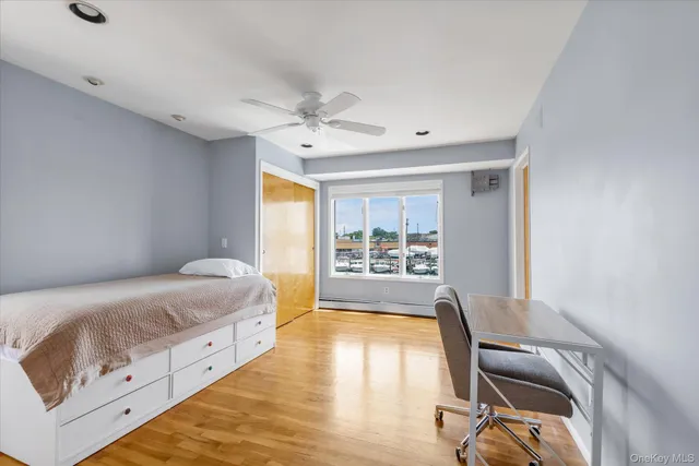 a bedroom with a bed and a desk