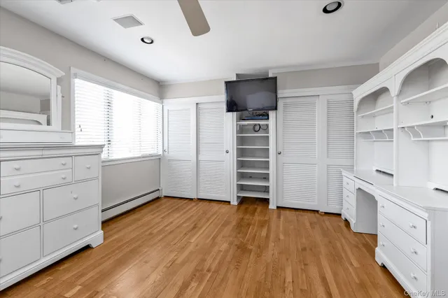 a view of a kitchen with wooden floor and electronic appliances