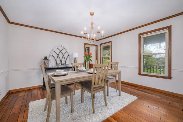 a view of living room kitchen with stainless steel appliances granite countertop cabinets and rug floor
