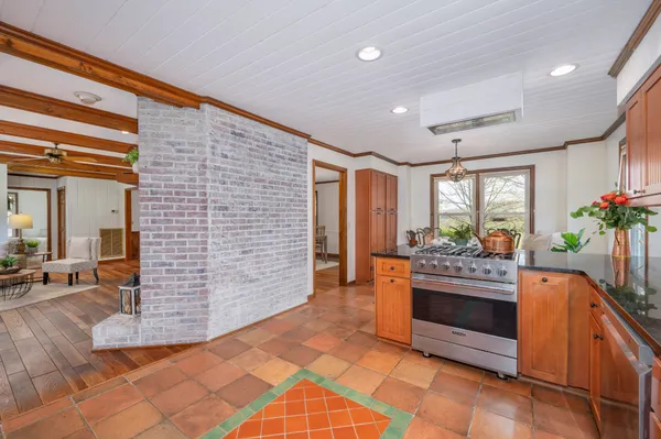 a bed sitting in a spacious bedroom next to a window