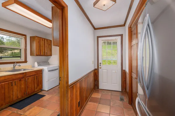 a spacious bedroom with a bed window and wall painting