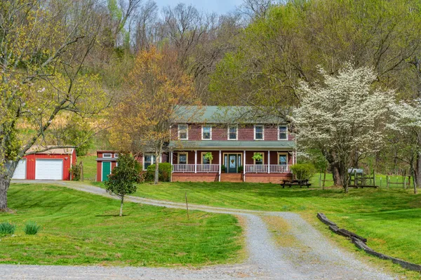 a view of a lush green hillside and a houses