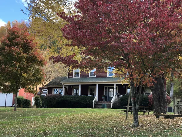 a front view of house with yard and green space