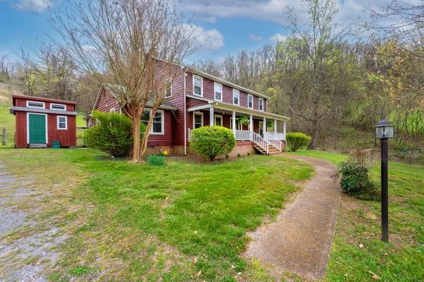 a front view of a house with a yard table and chairs