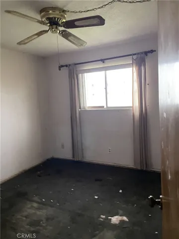 a view of room with window and ceiling fan