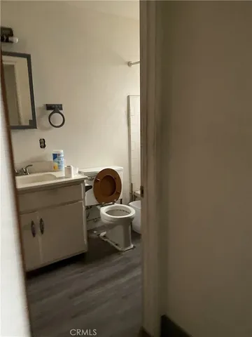 a bathroom with a toilet a sink and mirror
