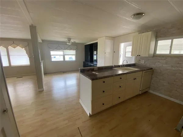 a kitchen with granite countertop a sink and a stove