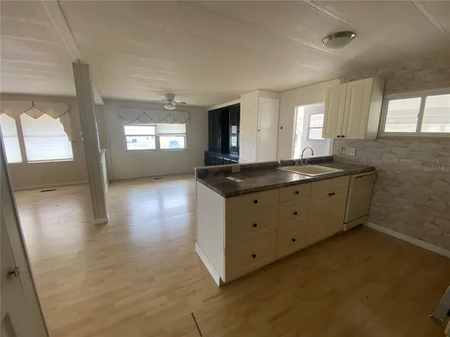 a kitchen with granite countertop a sink and a stove