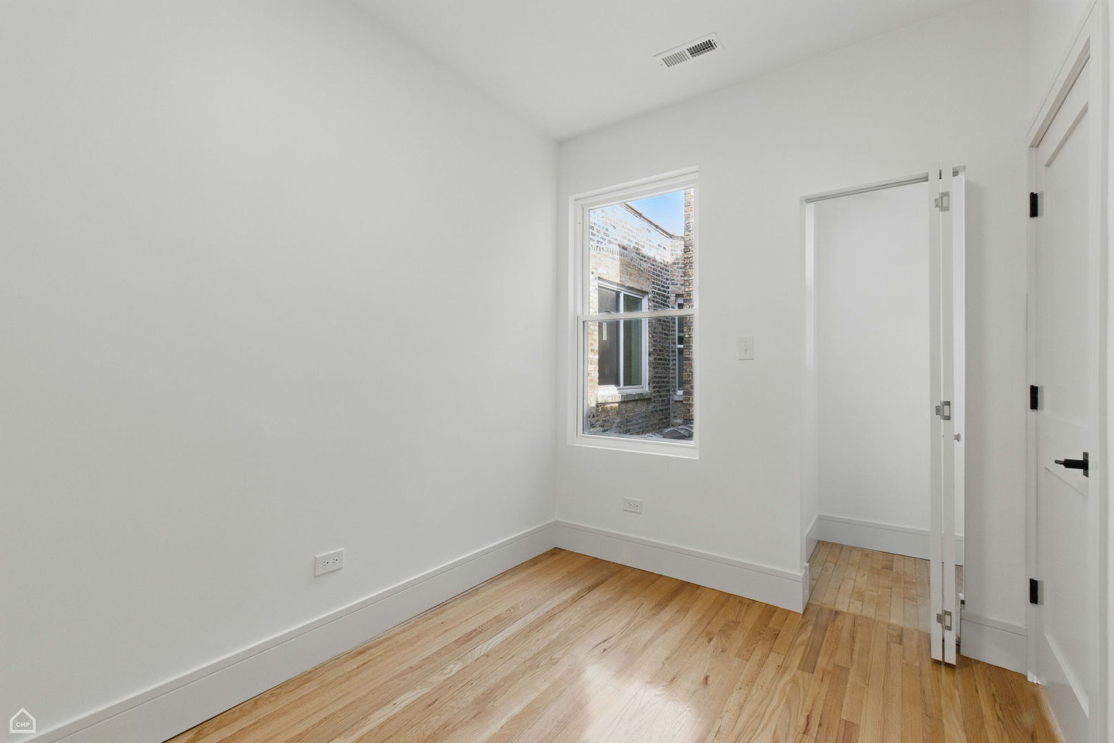 1928 West 21st Street, Unit 2F Chicago, IL 60608 - Photo 11 of 16 a view of empty room with wooden floor and fan