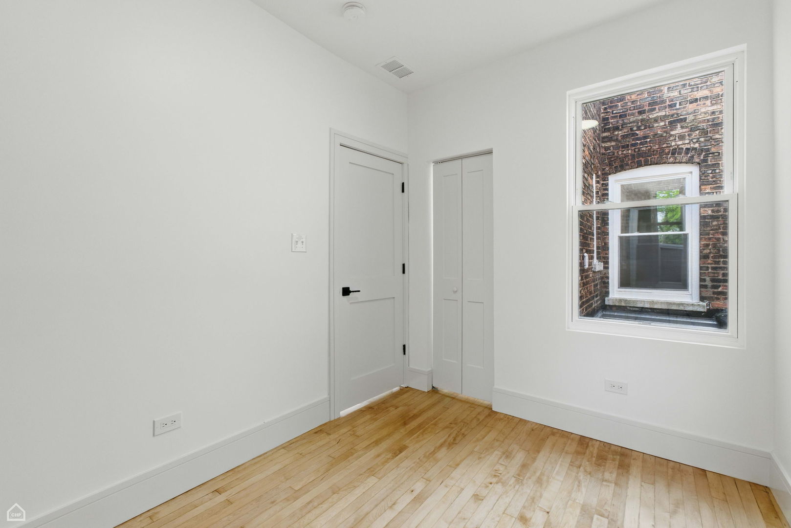 1928 West 21st Street, Unit 2F Chicago, IL 60608 - Photo 12 of 16 a view of an empty room with wooden floor and a window