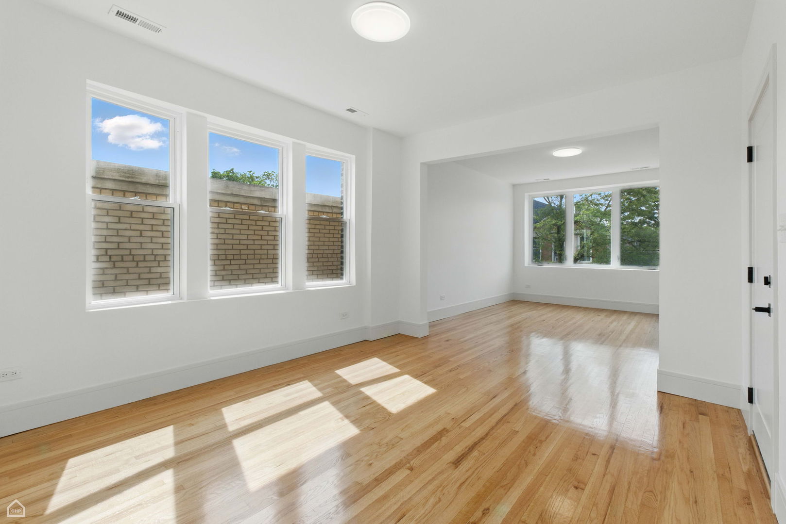 1928 West 21st Street, Unit 2F Chicago, IL 60608 - Photo 2 of 16 a view of an empty room with wooden floor and a window