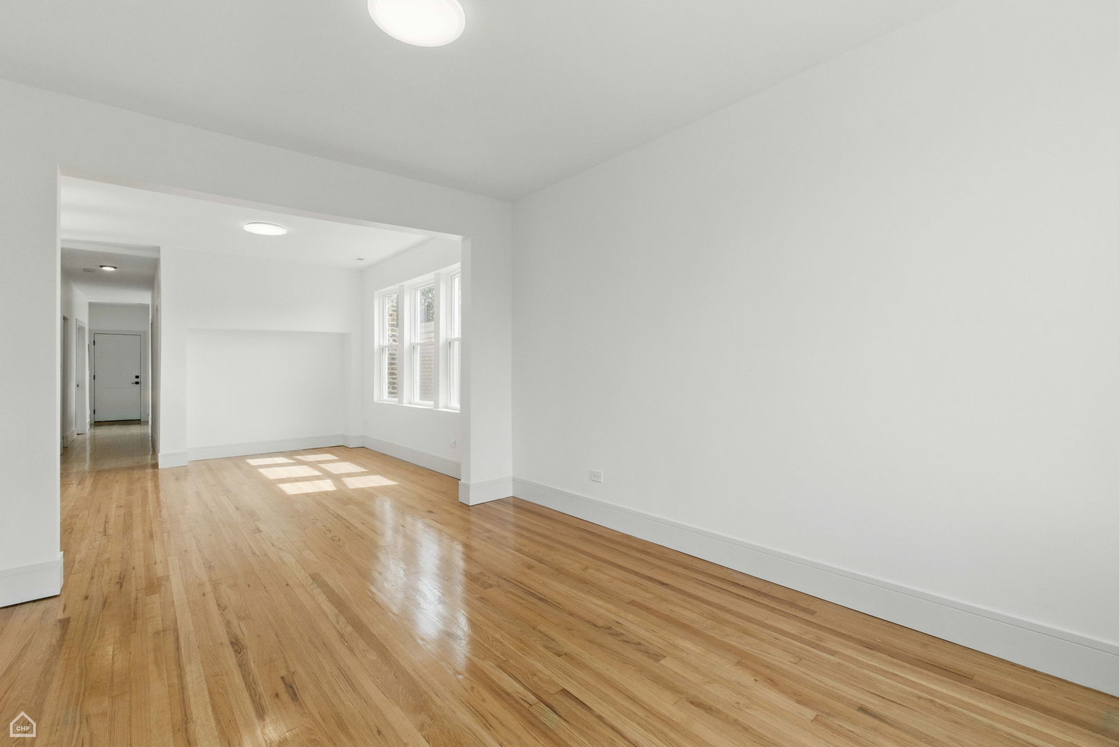 1928 West 21st Street, Unit 2F Chicago, IL 60608 - Photo 4 of 16 a view of empty room with wooden floor and fan