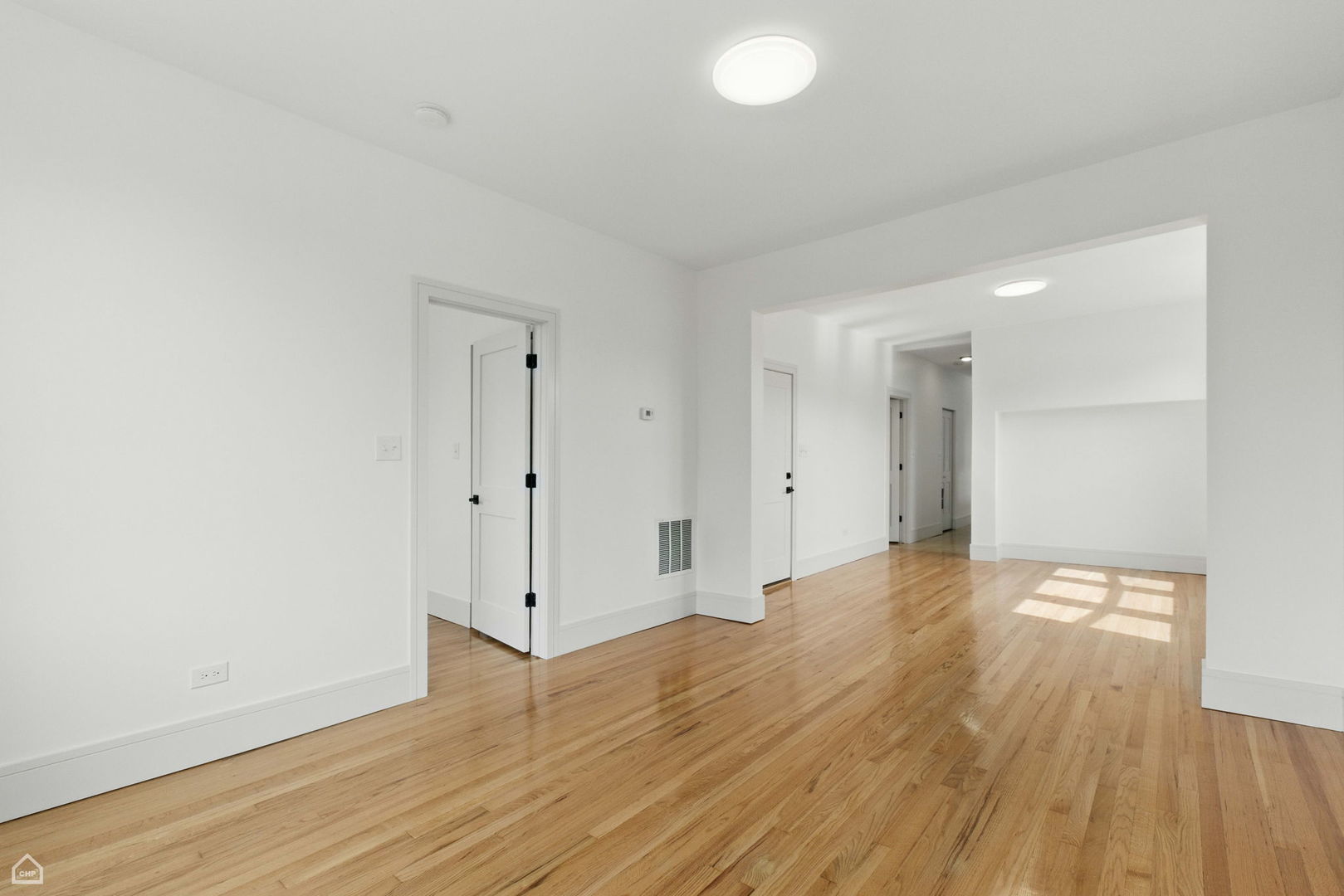 1928 West 21st Street, Unit 2F Chicago, IL 60608 - Photo 5 of 16 a view of an empty room with wooden floor