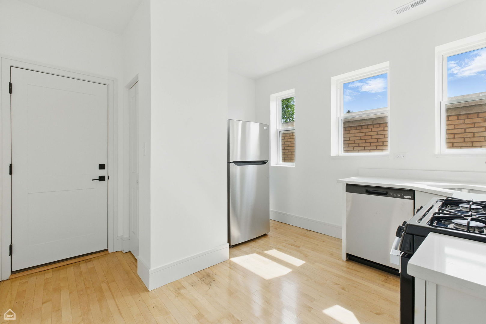 1928 West 21st Street, Unit 2F Chicago, IL 60608 - Photo 7 of 16 a kitchen with stainless steel appliances granite countertop a refrigerator and a stove