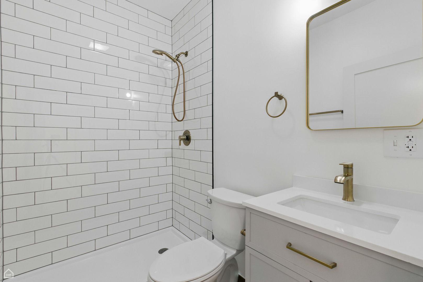 1928 West 21st Street, Unit 2F Chicago, IL 60608 - Photo 9 of 16 a bathroom with a toilet a sink a mirror and shower