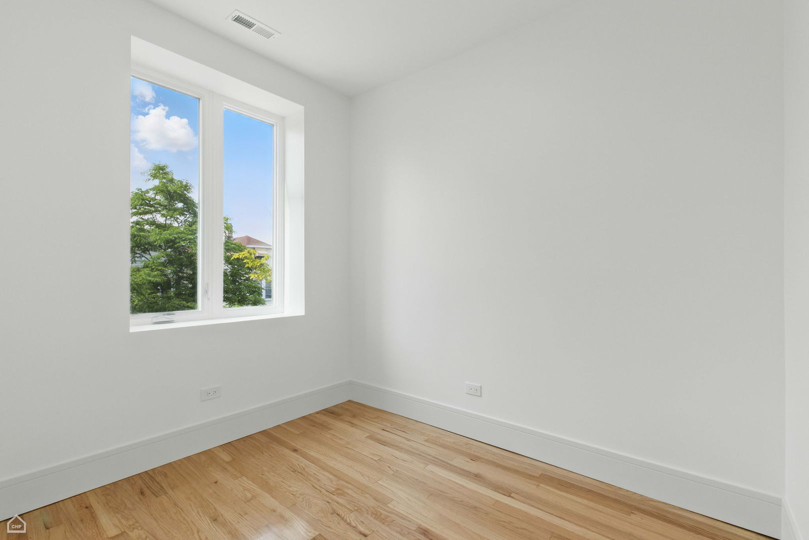1928 West 21st Street, Unit 2F Chicago, IL 60608 - Photo 10 of 16 a view of an empty room with wooden floor and a window