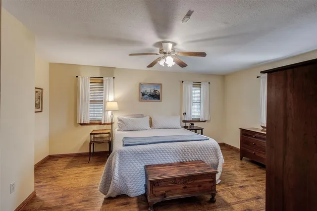 a bedroom with a bed dresser and a window