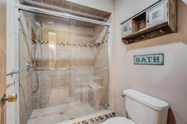 a bathroom with a shower a toilet and a sink