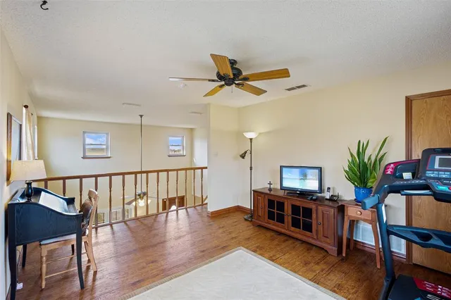 a living room with furniture stairs and a potted plant