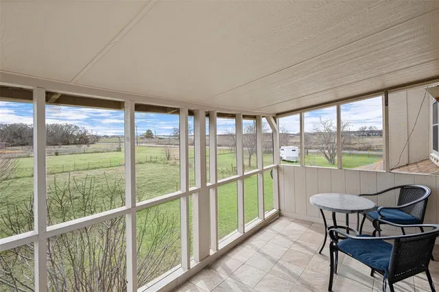 a view of a room with furniture and large windows