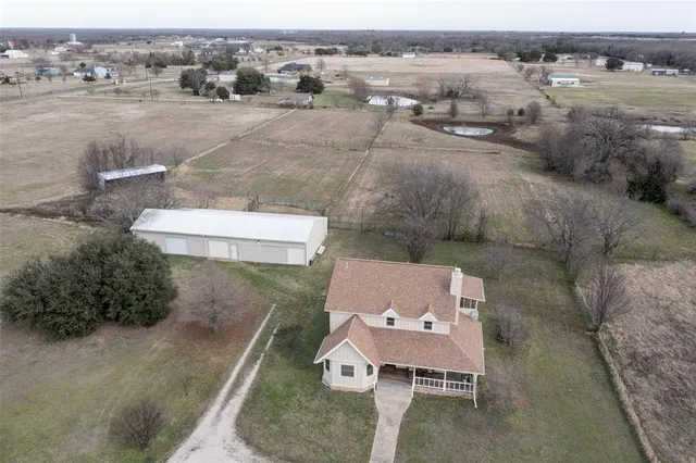 an aerial view of a house with outdoor space