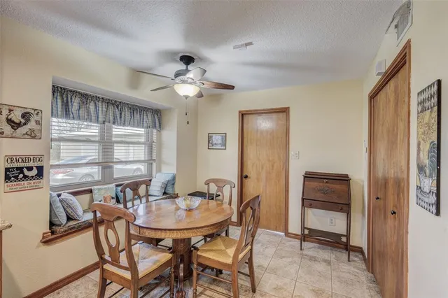 a view of a dining room with furniture and window