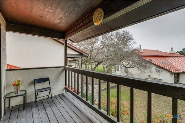 a view of a balcony with wooden floor