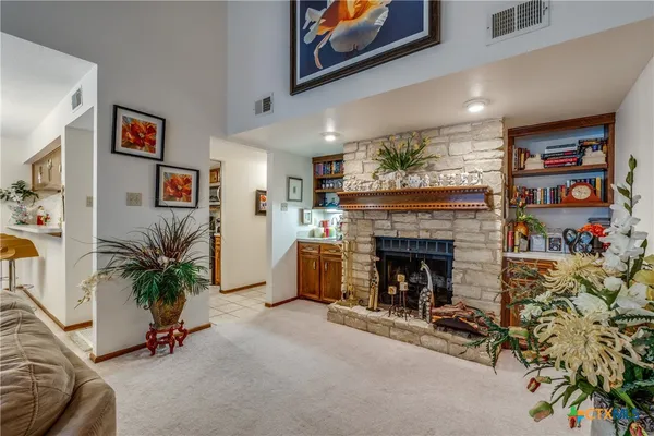 a living room with furniture and a fireplace