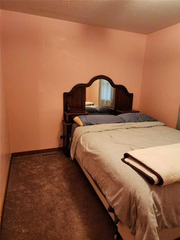 154 Bend Road New Wilmington, PA 16142 - Photo 10 of 22 a bed sitting in a bedroom next to a wall