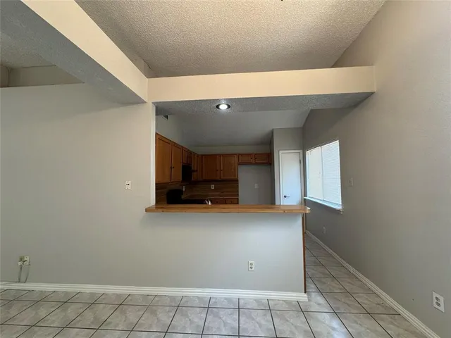 a view of a storage and utility room with wooden floor