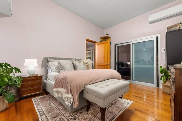 a bedroom with a bed and a potted plant