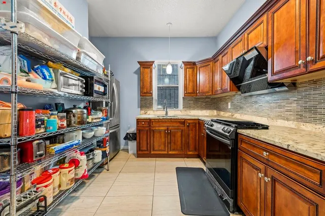 a kitchen with stainless steel appliances granite countertop a stove and cabinets