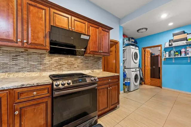 a kitchen with stainless steel appliances granite countertop a stove top oven microwave and refrigerator