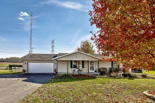 5901 Rotary Road Cherry Valley, IL 61016 - Photo 2 of 19 a front view of a house with a yard and garage