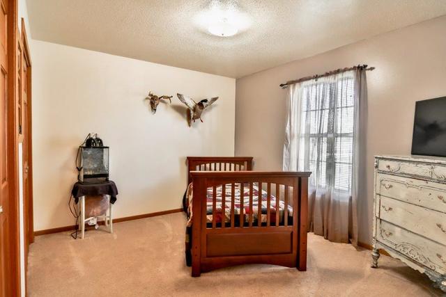 5901 Rotary Road Cherry Valley, IL 61016 - Photo 11 of 19 a bedroom with furniture and a window