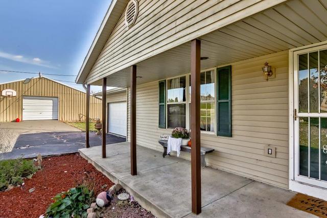 5901 Rotary Road Cherry Valley, IL 61016 - Photo 3 of 19 a view of a porch with a table and chairs