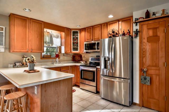 5901 Rotary Road Cherry Valley, IL 61016 - Photo 6 of 19 a kitchen with stainless steel appliances granite countertop a refrigerator a sink a stove and island