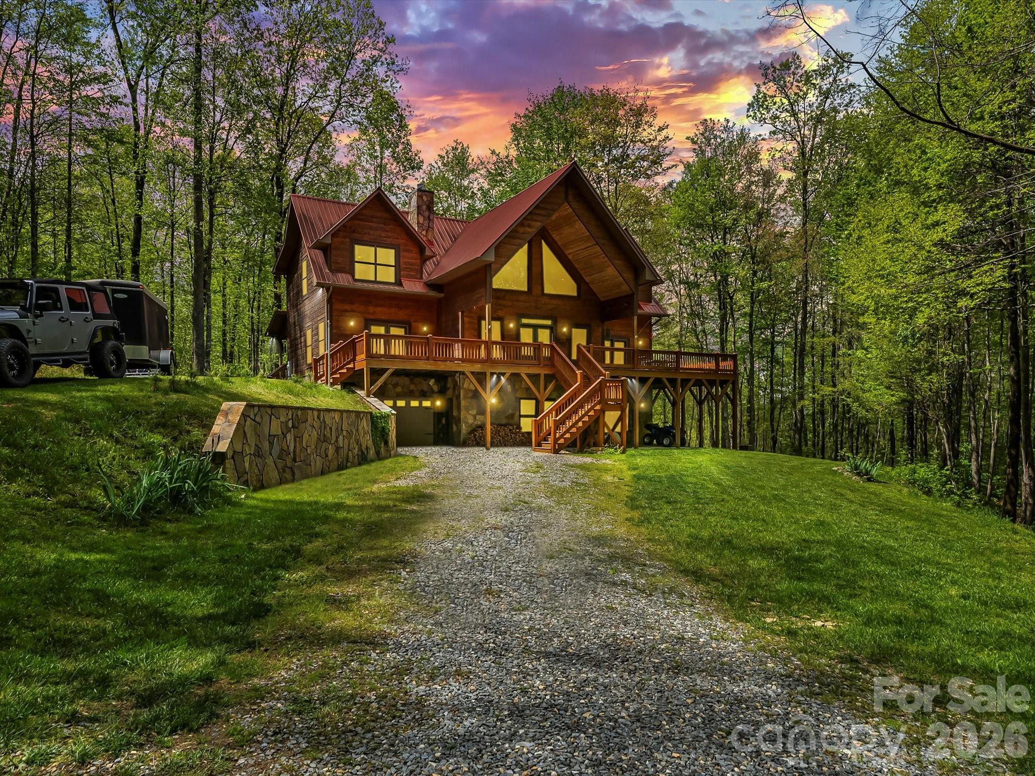 917 Otter Mountain Road Topton, NC 28781 - Photo 2 of 48 a view of a wooden house with a big yard and large trees