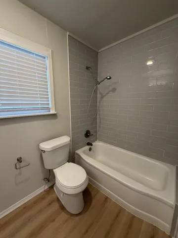 a bathroom with a toilet a sink and bathtub