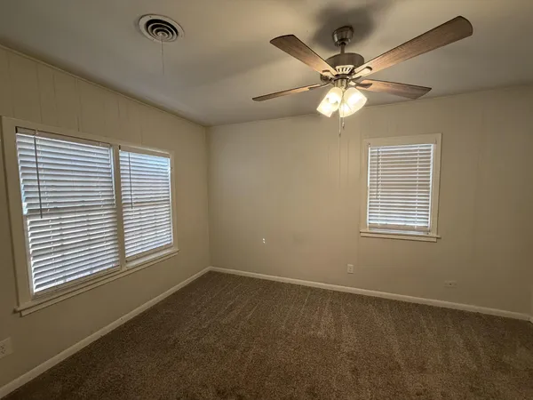 a view of a livingroom with a ceiling fan and a window