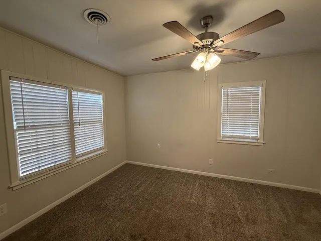 a view of a livingroom with a ceiling fan and a window