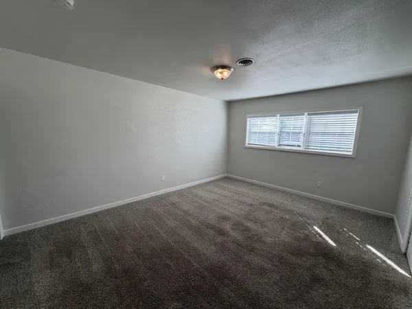 a view of an empty room with a window