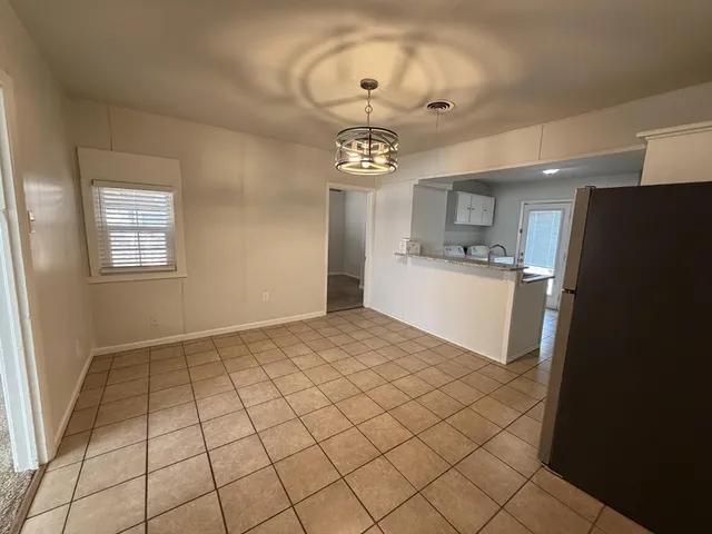 a view of a kitchen with a sink and a refrigerator