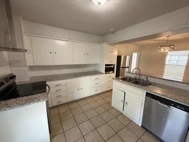a kitchen with a sink and cabinets