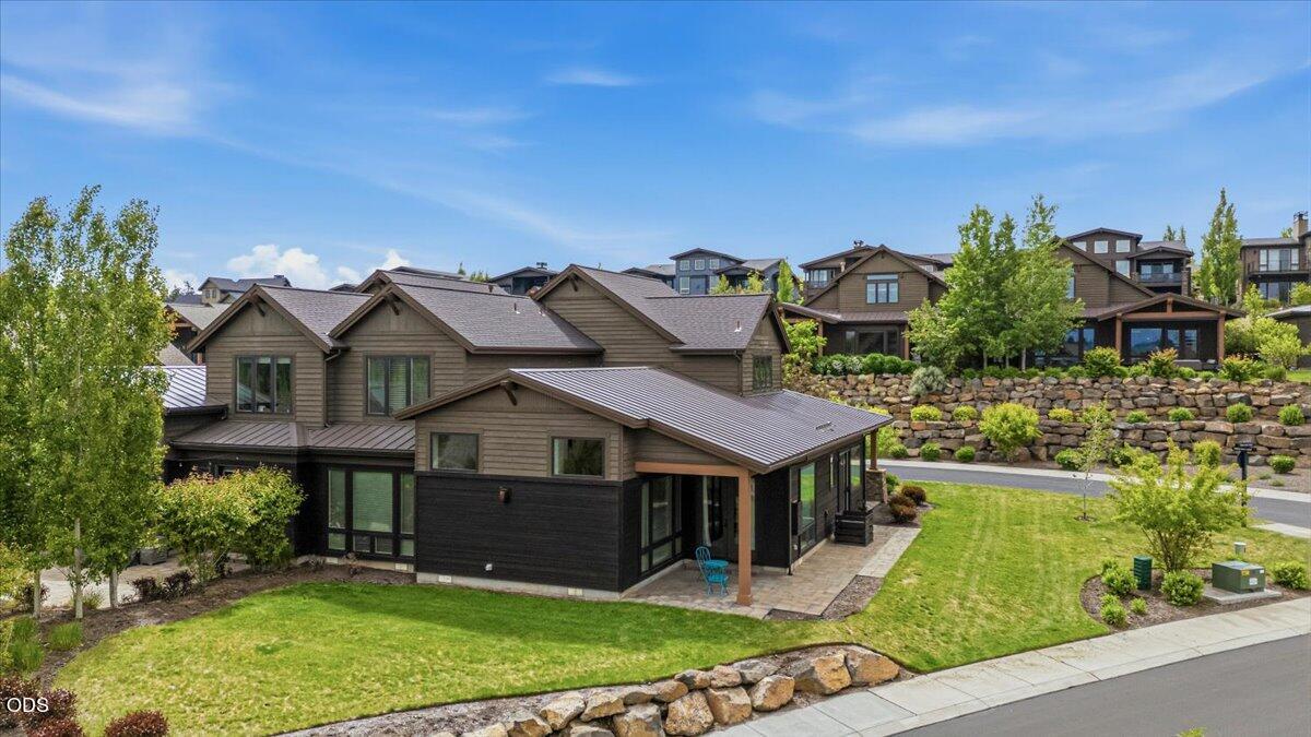 61333 Kindle Rock Loop Bend, OR 97702 - Photo 3 of 53 a aerial view of a house with a yard and table and chairs under an umbrella