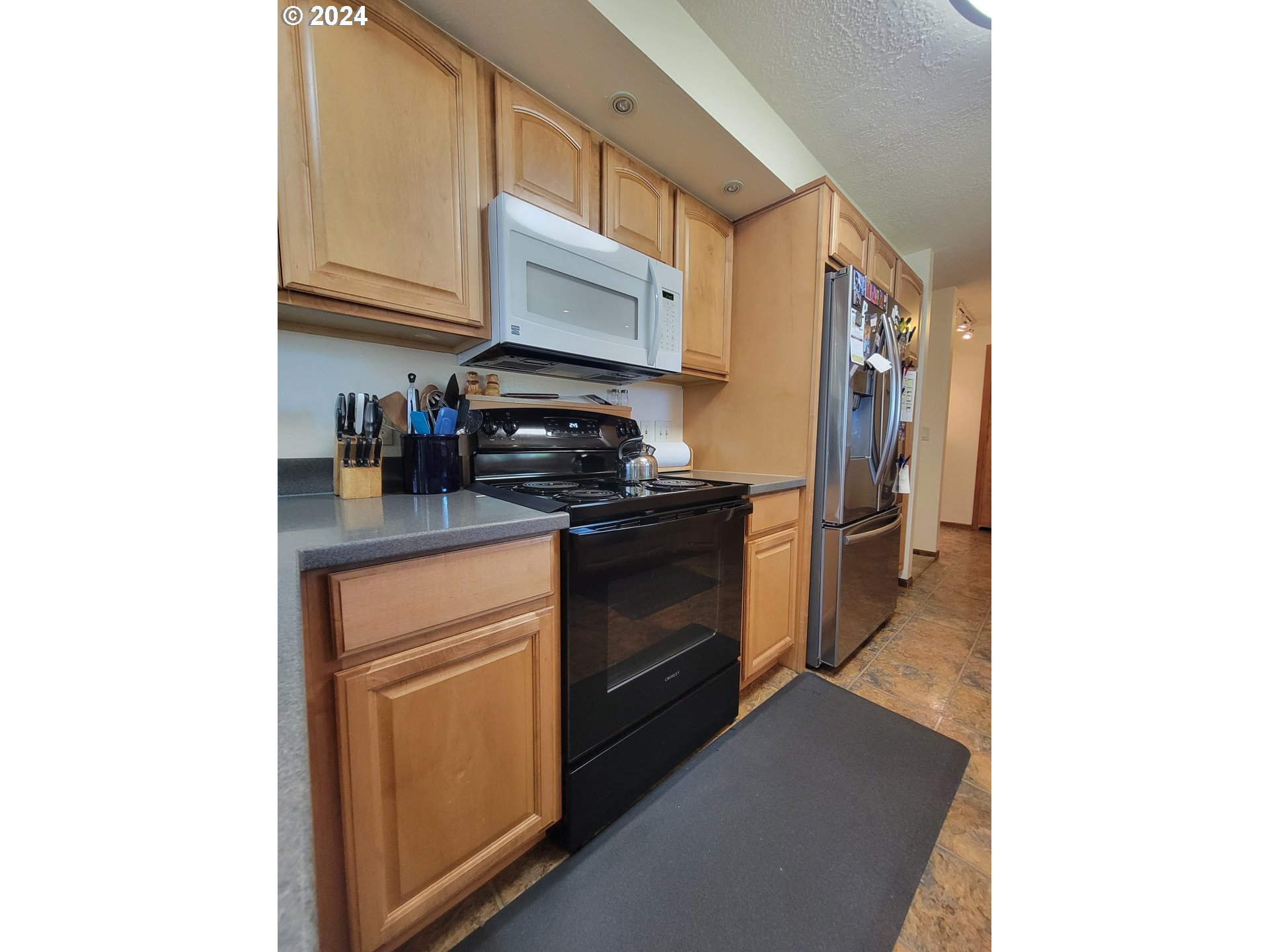 721 Southwest 29th Street Pendleton, OR 97801 - Photo 10 of 32 a kitchen with stainless steel appliances granite countertop a refrigerator and a stove
